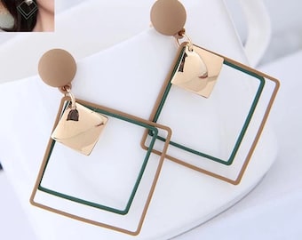 May include: A pair of gold, green, and brown geometric earrings with a square shape. The earrings have a small gold square charm hanging from them.