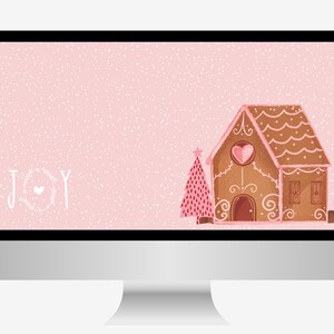 May include: A pink computer screen with a white gingerbread house and a pink Christmas tree. The background is a light pink with white dots. The text "JOY" is written in white with a heart in the middle of the "O".