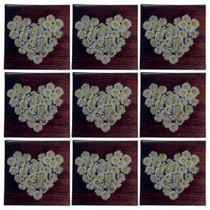 May include: Nine square tiles with a heart design made of white and yellow daisies. Each tile has a dark brown wood-grain background. The tiles are arranged in a three-by-three grid.