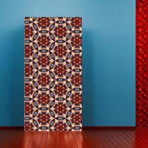 May include: A decorative wall panel with a repeating pattern of blue, white, and brown geometric shapes. The pattern is reminiscent of a kaleidoscope.