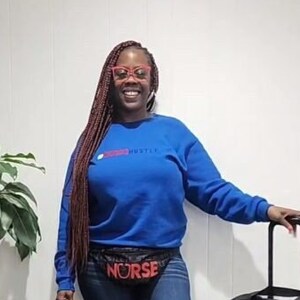 May include: A woman wearing a blue sweatshirt with the text "Nurse Hustle" in red, a black fanny pack with the text "Nurse" in red, blue jeans, red and white socks, and white sneakers. She is holding a black rolling suitcase with the text "Nurse Hustle" in red.