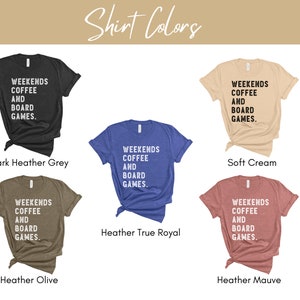 May include: Five t-shirts in different colors with the text "Weekends Coffee and Board Games." The colors are dark heather grey, soft cream, heather true royal, heather olive, and heather mauve.
