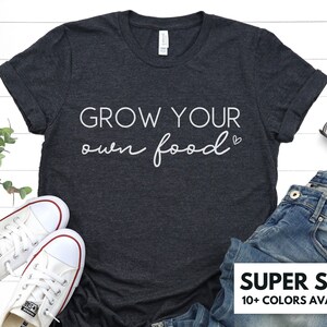 May include: A dark heather grey t-shirt with the text "Grow your own food" in white lettering. The shirt is super soft and available in 10+ colors.