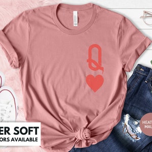 May include: A heather mauve t-shirt with a red queen of hearts graphic. The shirt is super soft and available in 10+ colors.