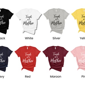 K&ouml;nnte beinhalten: Ein Set aus zehn T-Shirts in verschiedenen Farben, jedes mit dem Text "Tough as a Mother" in wei&szlig;er oder schwarzer Schrift.