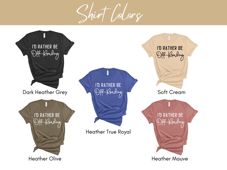 May include: Five t-shirts in different colors with the text "I'd rather be off-roading" printed in white. The colors are dark heather grey, soft cream, heather true royal, heather olive, and heather mauve.