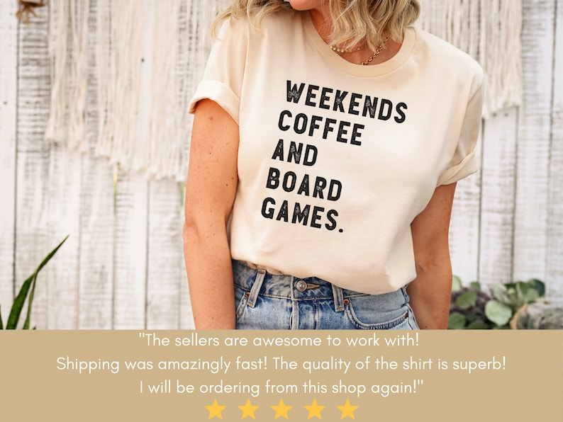 May include: A cream colored t-shirt with black text that reads "Weekends Coffee and Board Games."