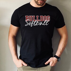 May include: A black t-shirt with the text "Bulldog Softball" in white and maroon lettering.