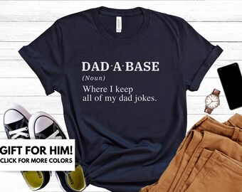 May include: A navy blue t-shirt with white text that reads "DAD: A BASE (Noun) Where I keep all of my dad jokes."