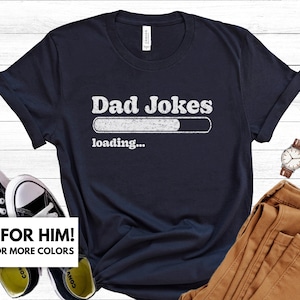 May include: A navy blue t-shirt with the text "Dad Jokes" and a loading bar graphic. The text "loading..." is below the graphic.