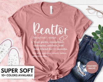 May include: A heather mauve t-shirt with the word "Realtor" defined as a tour guide, consultant, therapist, advisor, and best friend for 3+ months. The text also says "See also: magician, wizard, badass miracle worker."