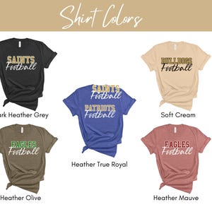 May include: Six different t-shirt colours with various team names and the word "Football" printed on them. The colours are dark heather grey, soft cream, heather true royal, heather olive, and heather mauve.