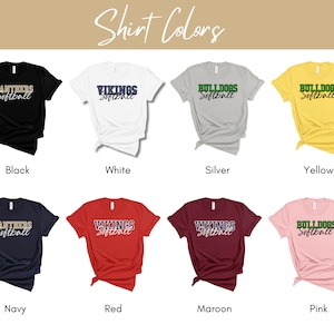 May include: Eight different color t-shirts with various team names and the word "Softball" printed on them. The colors are black, white, silver, yellow, navy, red, maroon, and pink.
