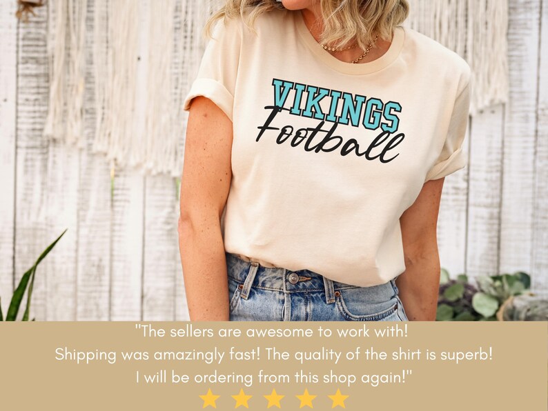 May include: A white t-shirt with a blue and black graphic that says "VIKINGS Football". The shirt is being worn by a person with long brown hair. The text below the image says "The sellers are awesome to work with! Shipping was amazingly fast! The quality of the shirt is superb! I will be ordering from this shop again!"
