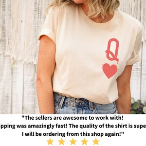 May include: A white t-shirt with a red queen of hearts graphic. The text "The sellers are awesome to work with! Shipping was amazingly fast! The quality of the shirt is superb! I will be ordering from this shop again!" is written below the image.