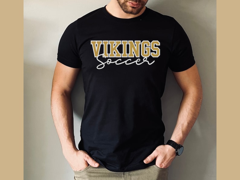 May include: Black t-shirt with gold text that reads "VIKINGS soccer"