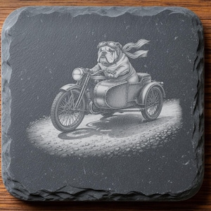 May include: A square slate coaster featuring a laser-engraved illustration of a bulldog wearing goggles and a scarf, riding a motorcycle with a sidecar. The text reads DIGITAL DOWNLOAD, LASER ENGRAVING FILE, LIGHTBURN, XTOOL, CO2, NOXTEC, and by EnhanceVision.
