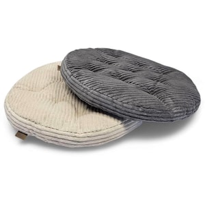 May include: Two corduroy seat cushions. One is a light beige color, and the other is a dark gray. Both are oval-shaped with a ribbed texture and a stitched pattern. The cushions are designed for comfort and support.