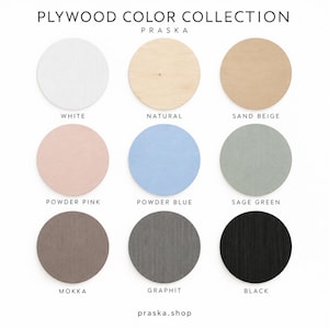 May include: A Plywood Color Collection chart by Praska featuring nine circular wood samples in white, natural, sand beige, powder pink, powder blue, sage green, mokka, graphit, and black. The text reads Plywood Color Collection, Praska, and praska.shop.