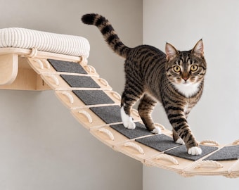 May include: A wall-mounted cat bridge made of light-colored plywood with a white corduroy-textured platform. The bridge features a series of rectangular wooden slats connected by thick white rope, each topped with a dark gray felt traction pad.