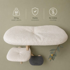 May include: A cream-colored corduroy wall-mounted cat shelf and a smaller matching step, featuring a 50 kg weight capacity, stable construction, and no visible mountings. A small grey felt platform with the Praska logo is included.