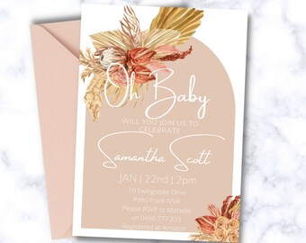 Op de afbeelding: Een babyblauwe babyshower-uitnodiging met een witte rand. De uitnodiging bevat een bloemstuk met gedroogd pampasgras en de tekst "Oh Baby" in witte letters. De tekst "Will you join us to celebrate Samantha Scott" staat ook in witte letters. De datum en tijd van de babyshower zijn aangegeven als "JAN | 22nd | 2pm". Het adres is "10 Ewingsdale Drive, Potts Point NSW". De RSVP-informatie is "Please RSVP to Michelle on 0456 777 333". De registratie-informatie is "Registered at Amazon".