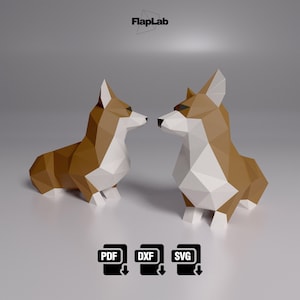 Puede incluir: Dos modelos de origami de papel de corgis marrones y blancos que se miran. Los corgis están hechos de papel doblado y tienen un efecto 3D. Los modelos están sobre un fondo gris. La imagen incluye el texto "FlapLab" en la parte superior.