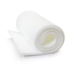May include: A white foam sheet rolled up for storage. The foam is thick and appears to be high density.