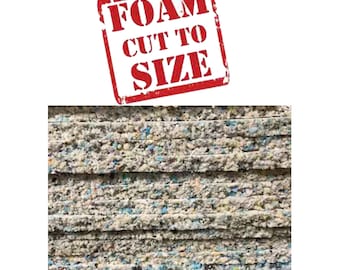 May include: Close-up of a stack of gray foam sheets with a red stamp that says "FOAM CUT TO SIZE".