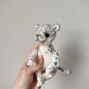 Stuffed snow leopard. Kawaii toy snow leopard. Knitted doll snow leopard. Small toy wild animal. Pocket toy snow leopard