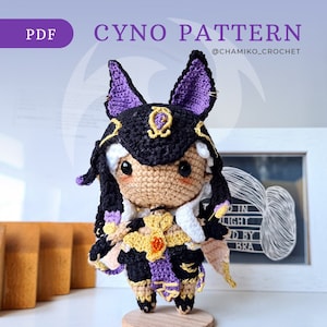 May include: A handmade crochet doll of a character with black and purple accents, large ears, and a detailed outfit. The doll is displayed on a wooden stand. Text on the image reads "CYNO PATTERN" and "@chamiko_crochet".