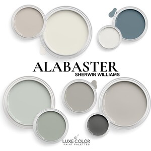 May include: Alabaster paint color palette by Sherwin Williams. The palette includes shades of gray, beige, and white. The paint colors are displayed in small paint can containers.