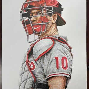 May include: A pen and ink drawing of a baseball catcher wearing a red and grey uniform with the number 10 on the front. The catcher is wearing a red helmet with a face mask and a grey chest protector.
