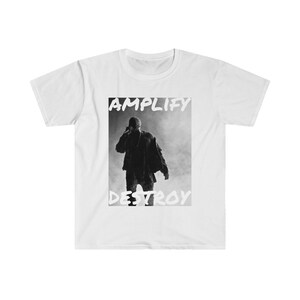 May include: White t-shirt with a black and white photo of a person wearing a hat and jacket. The text "AMPLIFY DESTROY" is printed in white on the shirt.