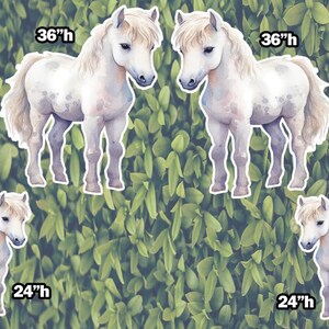 May include: Four white horse silhouettes with brown spots, in various sizes, with height measurements in inches. The horses are against a green leafy background.