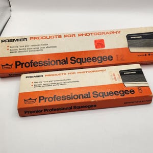 May include: Two orange and black boxes with the text "Premier Products for Photography" and "Professional Squeegee" on them. The boxes are for 8 and 12 inch squeegees.