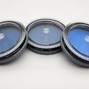Set of 3 Hasselblad B50 CB filters with plastic protective cases, 1x CB1.5 -0, 1.4x CB3 -0.5, and 2x CB6  -1. Excellent condition