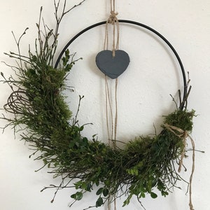 Metal ring half-bound with a slate heart