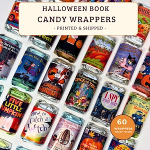 May include: A collection of rectangular candy wrappers featuring colorful illustrations and titles of various Halloween-themed children's books. Each wrapper is individually wrapped in shiny silver foil, showcasing diverse graphic designs and text.
