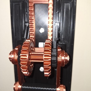 May include: A copper-colored steampunk-style light switch with a black background. The switch has a lever with gears and a handle.
