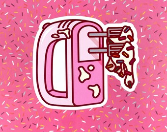 May include: A pink sticker of a hand mixer with white frosting and colorful sprinkles. The mixer is outlined in dark pink and has white accents. The background is pink with scattered sprinkles.