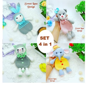 May include: Set of four crocheted stuffed animals: a bunny, a cat, a bear, and an elephant. Each animal is wearing a different colored outfit with a ruffle collar. The animals are all gray with white accents. The text "SET 4 in 1" is in the center of the image.