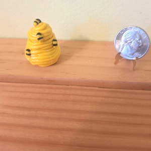Dollhouse miniature beehive cookie jar, complete with tiny bees witting on the hive