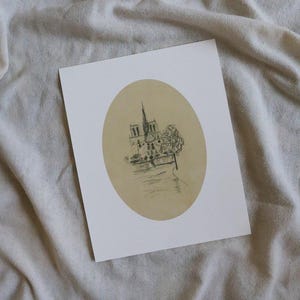 May include: A black and white line drawing of the Notre Dame Cathedral in Paris, France. The drawing is on a beige background and is framed in a white oval.