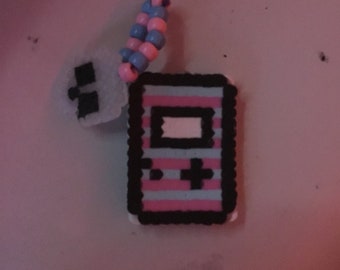 Pink and blue handheld game and skull perler