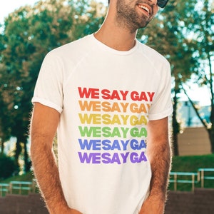 Attn Ron DeSantis: We Say Gay | LGBTQ | Gay Rights | Ally | Queer Apparel | T-Shirt