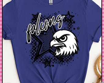May include: A blue t-shirt featuring a graphic design with the word "falcons" in a script font, a star with a checkerboard pattern, and a white eagle head. The shirt also has the text "Checkerboard and Stars".