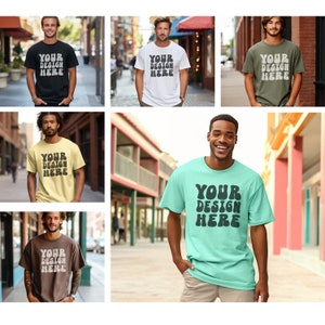 May include: Six different men's t-shirts in various colors, including black, white, yellow, green, brown, and light blue. Each shirt features the text "YOUR DESIGN HERE" in a retro, stylized font.
