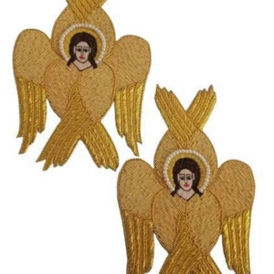 May include: Two gold embroidered angel patches. Each patch features a detailed angel with a halo, wings, and a serene facial expression. The wings are intricately designed with a textured, layered appearance.