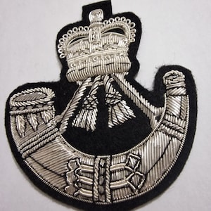 Insignia de chaqueta con lingotes bordados con alambre de fusiles - Ejército británico.